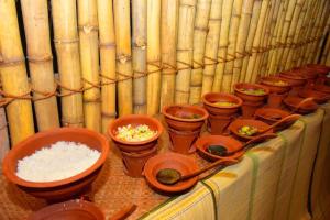 a group of bowls of rice sitting on a table at Enjoy River Cottage in Udawalawe