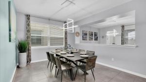 a dining room with a black table and chairs at 1840 Caribbean View in Kissimmee