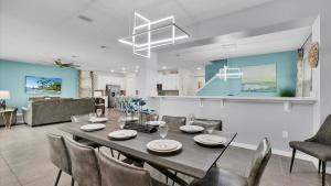 a dining room and living room with a table and chairs at 1840 Caribbean View in Kissimmee +71 photos