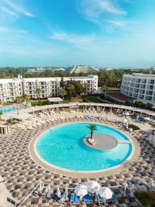 a swimming pool with chairs and a resort at Kaya Side in Side