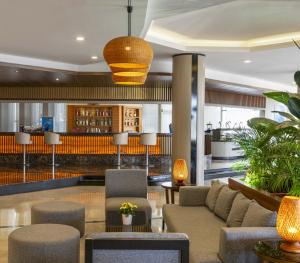 a lobby with a couch and chairs and a bar at Kaya Side in Side