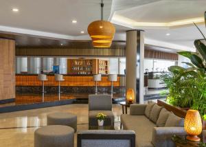 a lobby with a couch and chairs and a bar at Kaya Side in Side