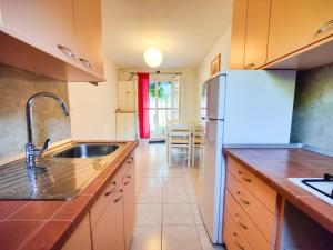 a kitchen with a sink and a refrigerator at Robinson Dionis in Selca kod Bogomolja +20 photos