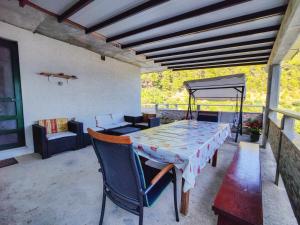 a patio with a table and chairs and a couch at Robinson Dionis in Selca kod Bogomolja