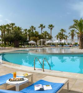 a pool at a resort with a table and chairs at Kaya Side in Side
