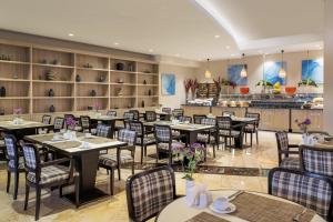 a restaurant with tables and chairs in a room at Kaya Side in Side