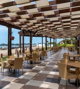 a restaurant with tables and chairs on the beach at Kaya Side in Side