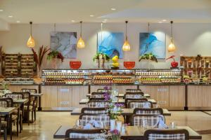 a restaurant with tables and chairs and a bar at Kaya Side in Side