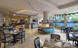a restaurant with tables and chairs and a kitchen at Kaya Side in Side