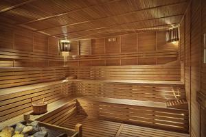 an empty sauna with wooden walls and wooden floors at Kaya Side in Side