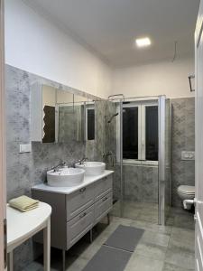 a bathroom with two sinks and a shower and a toilet at Exclusive apartment in Supetarska Draga +21 photos