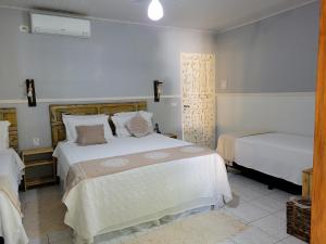 a bedroom with two beds in a room at Pousada Beach Bahia in Porto Seguro +215 photos