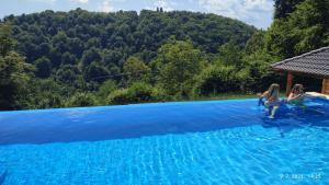 two girls playing in a blue swimming pool at Laganini Country in Samobor