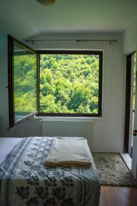 a bedroom with a bed and a large window at VIP Rooms Foča, Accommodation Foca, Foca Rooms in Foča