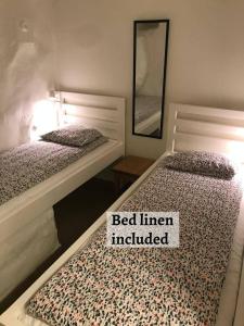two beds in a bedroom with a bed liner included at Hostel Dalagatan in Stockholm