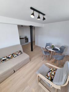 a living room with a couch and a table at Apartamenty Welskie in Lidzbark