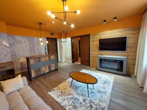 a living room with a couch and a tv at Bucharest Comfort Suites Hotel in Bucharest