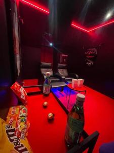 a room with a table with two soda bottles on it at La Suite Casa Dé lové 2.0 jacuzzi & cinema privé in Melun