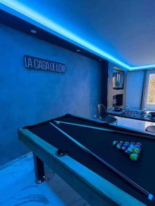 a pool table in a blue room with a sign at La Suite Casa Dé lové 2.0 jacuzzi & cinema privé in Melun