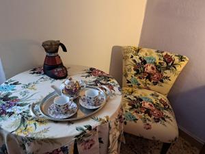 a table with a tea pot and cups on a chair at Casa Luci d'Alba in Monzambano