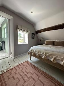 sypialnia z dużym łóżkiem i oknem w obiekcie Cosy Cottage in Lechlade w mieście Lechlade