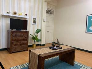 a living room with a coffee table and a flat screen tv at Dominos 1 BHK Apartment, Near Carter Road by Connket Homes in Mumbai