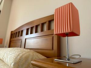 czerwone światło na stole obok łóżka w obiekcie Apartamento Salgueirón w mieście Cangas de Morrazo