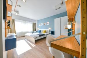 um quarto de hotel com uma cama e uma secretária em My Place Titulescu 2 em Cluj-Napoca