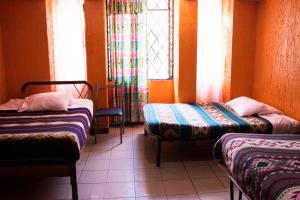 Postel nebo postele na pokoji v ubytování Hostal Carlos Luis