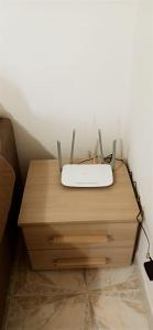 a router sitting on a wooden table in a room at Casa Fiore Olbia in Olbia