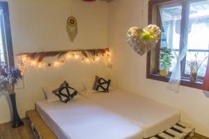 two beds in a room with lights and a window at Cha Cha Backpackers in Martvili