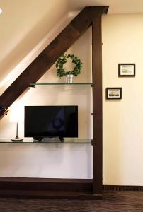 a living room with a tv on a wall at Sleephotels in Hamburg