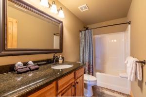 a bathroom with a sink and a tub and a toilet at Mayapple Ridge in Sugar Grove +31 photos