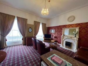 a living room with a couch and a fireplace at Eden Vale First Floor Sea View Apartment in Morecambe