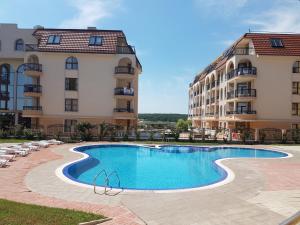 a swimming pool in front of a building at Sinemorets Cliffs in Sinemorets