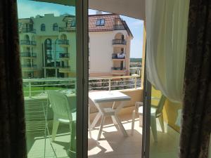 a room with a balcony with a table and chairs at Sinemorets Cliffs in Sinemorets