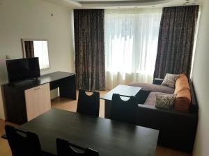 a living room with a couch and a table at Sinemorets Cliffs in Sinemorets