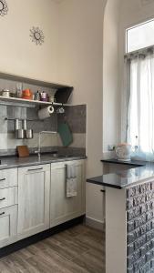a kitchen with a sink and a counter top at Bilocale Carrara Centro con giardino e parcheggio moto in Carrara