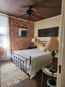 a bedroom with a bed and a ceiling fan at Back Inn Time in Saint Albans