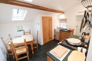 a kitchen and dining room with a table and a dining room at Sedbergh Cottage, Sedbergh in Sedbergh