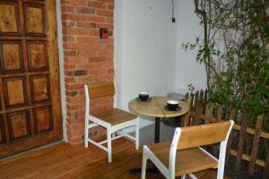 a table and two chairs and a table with cups on it at Magic Wood Studio Apartament Koniewo in Lidzbark Warmiński