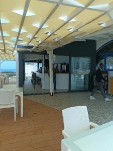 a person walking in a room with tables and chairs at Sunny, big pool, garden-roof terrace view Cornervilla on area Kyrenia-Bahceli North-Cyprus in Bahçeli +46 photos
