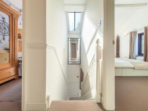 a white staircase in a bedroom with a bed at Stunning Country 4 bedroom Cottage for weekly or monthly stays in Honiley