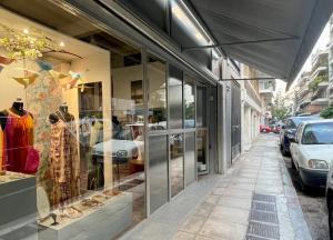 a store front of a street with a store window at Loft studio in Pagrati in Athens
