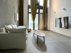 a living room with a couch and a coffee table at Loft studio in Pagrati in Athens