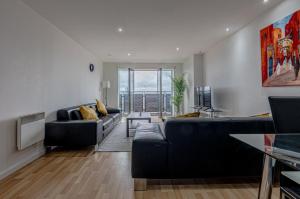 a living room with a couch and a table at Amazing Views - 2 Bed - Parking - Central Bham in Birmingham