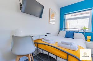 a bedroom with a bed with a desk and a chair at Monthly Offers, 10 Guests, Business, WIFI in Derby +7 photos