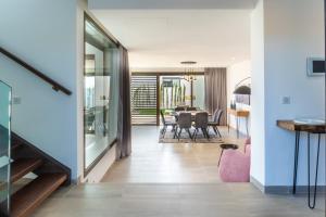 a dining room and living room with a dining table at Salam Taghazout - luxury villa - Pool - 8 Px in Taghazout +20 photos