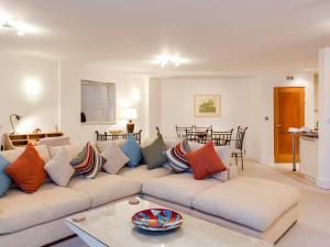 a living room with a couch with colorful pillows at Riva - sea views in Poole