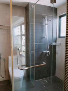 a bathroom with a glass shower with a toilet at Townhouse OAK 591 Shah Alam By Salaam Suites in Shah Alam